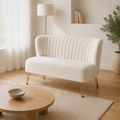 Angle | front-right view of the ivory velvet channel-tufted armless loveseat in the warm-white living room