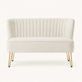 Front | straight-on studio view of the ivory velvet channel-tufted armless loveseat with four gold hairpin legs