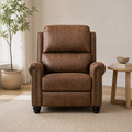 Warm white room | brown mottled faux-leather push-back recliner with rolled arms and dark nailhead rows beside a pale oak side table