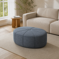 Angle | three-quarter view of the ottoman in the warm living room