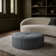 In a room | olive plaster library with the slate gray-blue ottoman on a warm gray rug