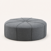Studio | studio view of the oval ottoman with its corded top and front panels