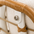 Close detail | wicker-wrapped arm, white metal tube, rope tie, and silver bolt