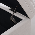 Hardware close-up | dark metal hinge and flip-top support beside the black-lined storage cavity and light gray tufted lid