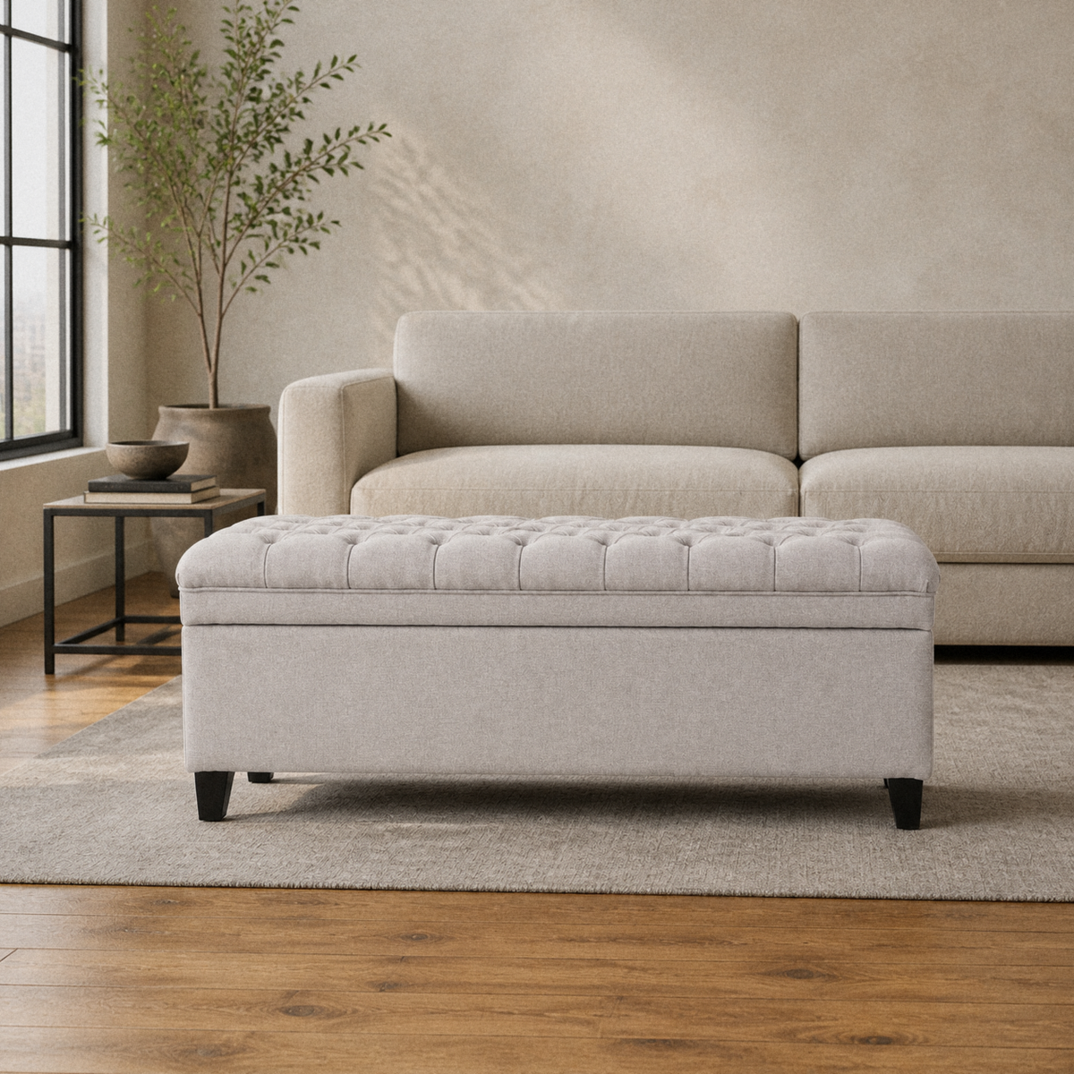 Room | light gray polyester storage ottoman with a diamond-tufted flip top, plain upholstered body, and tapered dark wood legs in a warm loft living room
