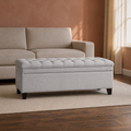 Room | light gray polyester storage ottoman with a diamond-tufted flip top and plain upholstered body on a dark walnut floor in a warm clay living room