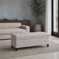 Room | light gray polyester storage ottoman with a diamond-tufted flip top and plain upholstered body in a cool blue-gray living room with a French door