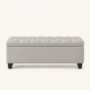 Front | light gray polyester storage ottoman in a clean studio front view, diamond tufting on the flip top, plain body, and four tapered dark wood legs