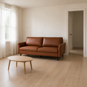Scale | Mid-brown faux leather sofa beside a full-height doorway in a bright room