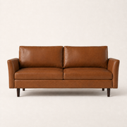 Front | Mid-brown faux leather sofa with flared arms and two loose back cushions on a clean studio ground