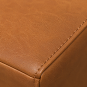 Texture | Mid-brown faux leather upholstery grain and stitched seat edge