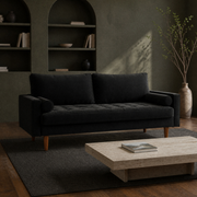 In a room | black velvet tufted sofa in an olive library with a travertine coffee table