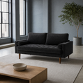 In a room | black velvet tufted sofa in a blue-gray loft with steel windows, a pale rug, and a light oak coffee table