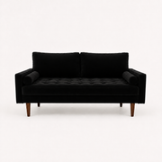 Front | front studio view of black velvet sofa with a square-tufted bench cushion, two cylindrical bolsters, and tapered brown wood legs