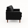 Side | left-side studio profile of black velvet sofa showing the square arm, back cushions, tufted bench, and brown wood legs