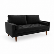 Studio | front-left studio view of black velvet sofa showing the square arm, tufted bench seat, two loose back cushions, and brown wood legs