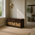 Angle | three-quarter view of dark cherry storage bench with drawers and woven baskets in a pale olive entry