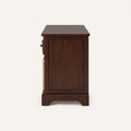 Side | right-side studio view of dark cherry storage bench with inset wood panel and short base rail