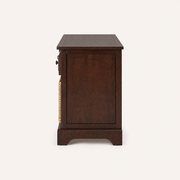 Side | right-side studio view of dark cherry storage bench with inset wood panel and short base rail