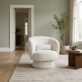 In scale | cream white boucle swivel chair beside an uncropped full-height interior doorway
