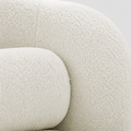 Material close-up | cream white looped boucle upholstery on the chair's rounded arm and bolster
