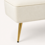 Gold leg detail | Tapered gold metal loveseat leg with ivory velvet upholstery edge