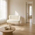Scale | Ivory velvet armless loveseat beside a full-height doorway in a bright room