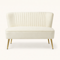Front | Ivory velvet armless loveseat with channel tufting and four gold metal legs on a clean studio ground