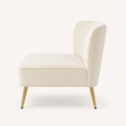 Side | Side profile of ivory velvet armless loveseat with a curved channel-tufted back and gold legs