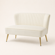 Studio angle | Three-quarter studio view of the ivory velvet armless loveseat with gold metal legs