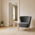 Scale | Grey velvet accent chair beside a full-height doorway in a neutral room