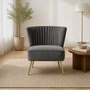Living room | Grey velvet channel-tufted accent chair with four gold metal legs in a warm white room