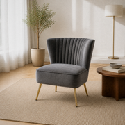 Living room angle | Grey velvet channel-tufted accent chair from a three-quarter angle in the warm white room