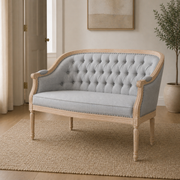 Scale | Compact black faux leather loveseat beside a full-height interior doorway for scale