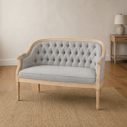 Warm room | Midnight black faux leather loveseat in a terracotta garden room with arched window and plain indigo rug