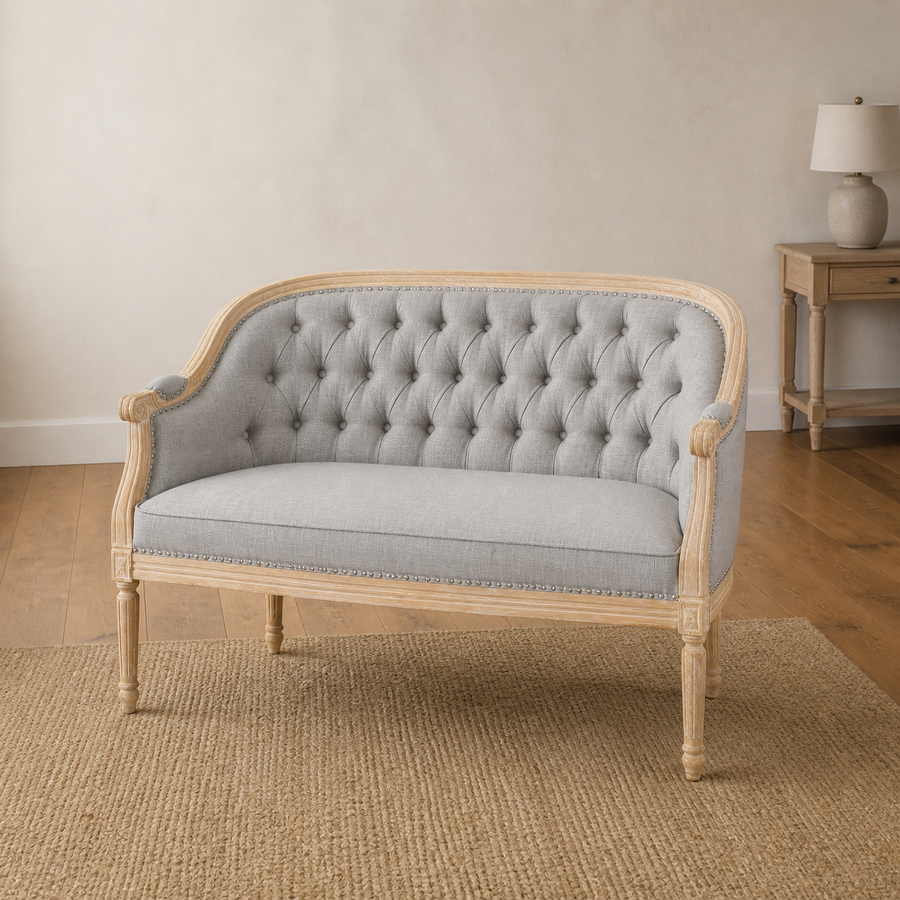Warm room | Midnight black faux leather loveseat in a terracotta garden room with arched window and plain indigo rug