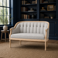 Library | Black faux leather loveseat in a deep navy library with cream rug and herringbone wood floor