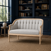 Library | Black faux leather loveseat in a deep navy library with cream rug and herringbone wood floor
