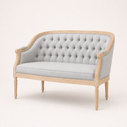 Studio angle | Three-quarter view of the black tufted loveseat, curved birch frame, nailhead trim, and turned legs