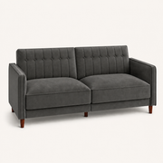 Studio | Three-quarter studio view of the square arms, chevron tufting, and brown tapered legs