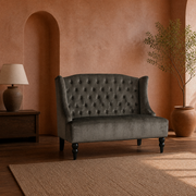 In a room | charcoal gray velvet diamond-tufted wingback loveseat in a terracotta garden room