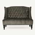Front | straight-on studio view of the charcoal gray velvet diamond-tufted wingback loveseat with black legs