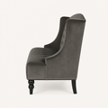 Side | right-side studio profile of the charcoal gray velvet diamond-tufted wingback loveseat with black legs
