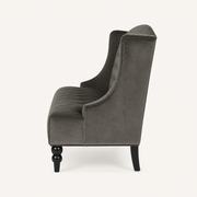 Side | right-side studio profile of the charcoal gray velvet diamond-tufted wingback loveseat with black legs