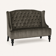 Studio | front-right studio view of the charcoal gray velvet diamond-tufted wingback loveseat with black legs