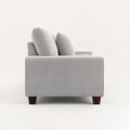 Side | Left-side studio view showing the square arm, back cushion profile, black center support, and brown wood legs