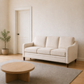 In scale | beige three-seat sofa beside a fully visible interior doorway