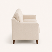 Studio side | beige sofa profile showing the sloped arm and brown tapered legs