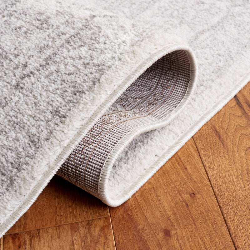 Folded corner | one corner turned back on a wood floor to show the backing