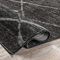 Folded corner | one corner turned back on a wood floor to show the backing